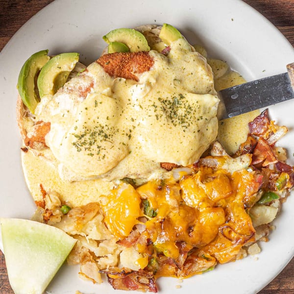 Foodys Tampa's chicken fried steak with avocado, hollandaise, and cheesy hash browns.